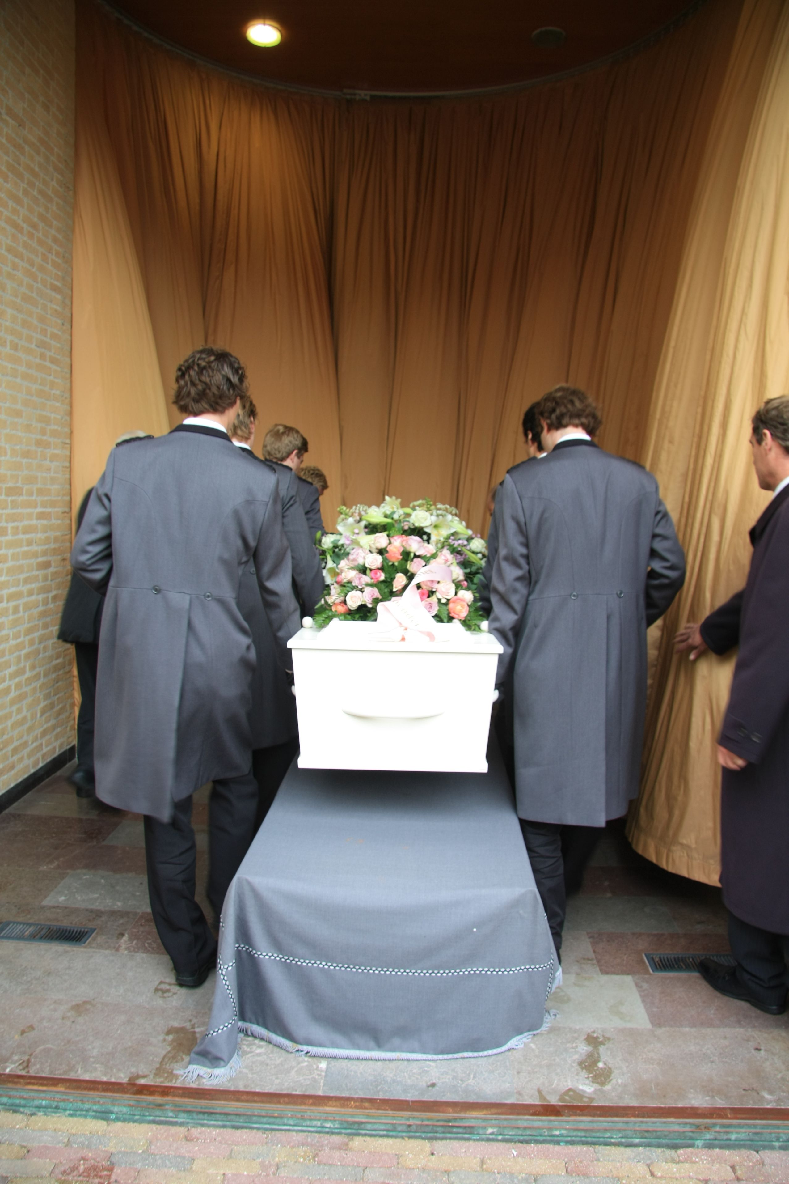 11194230-xl-funeral-home-employees-preparing-a-casket-for-a-funeral